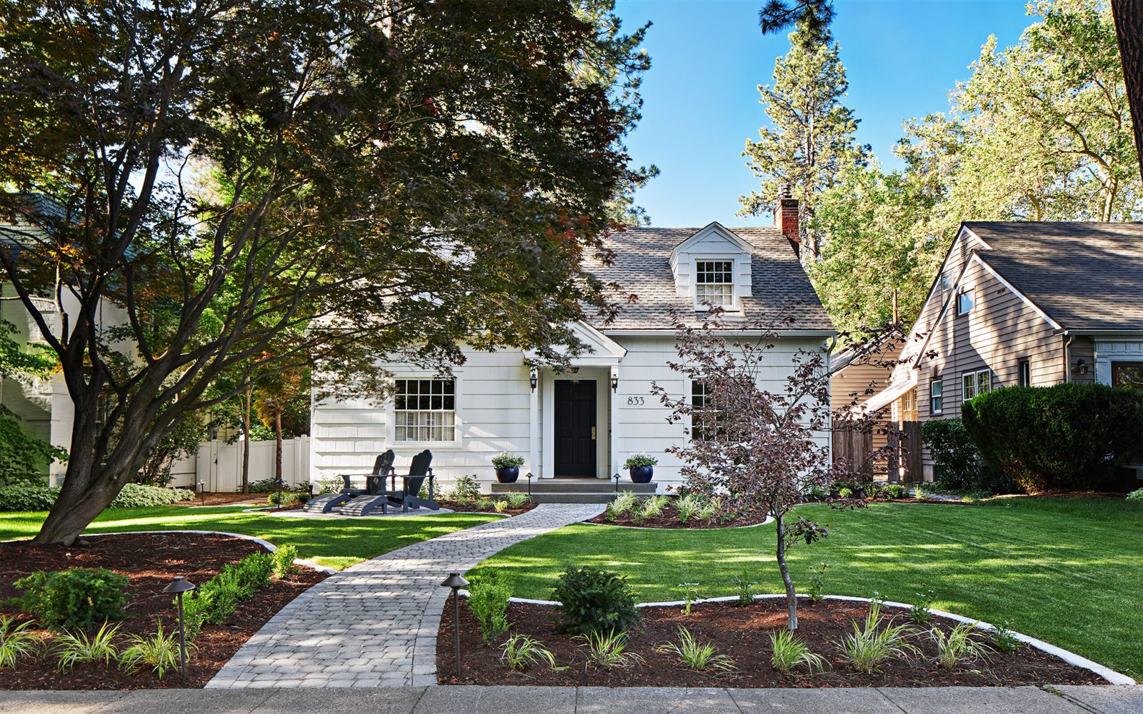 A pristine Wesley Chapel front yard with manicured lawn, paver walkway, and fresh landscape beds maintained by Varro Grounds Management